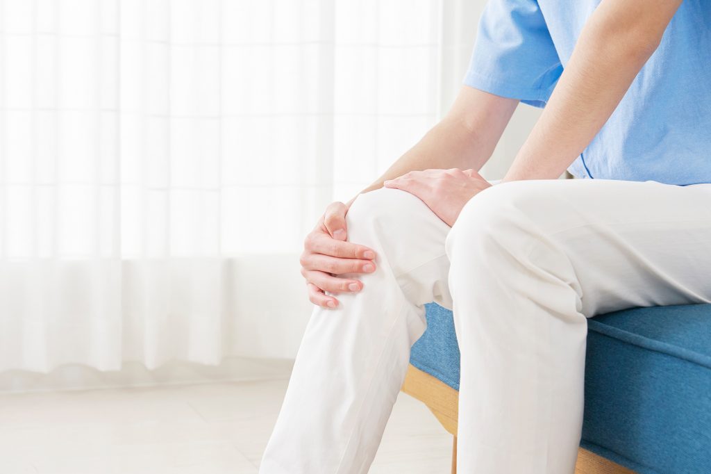 Man holding knee with joint pain