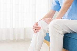 Man holding knee with joint pain