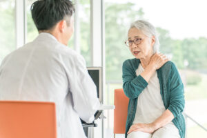 An elderly woman suffering from rheumatoid arthritis