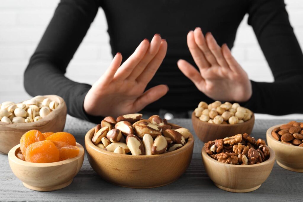 A woman declining food that she is allergic to