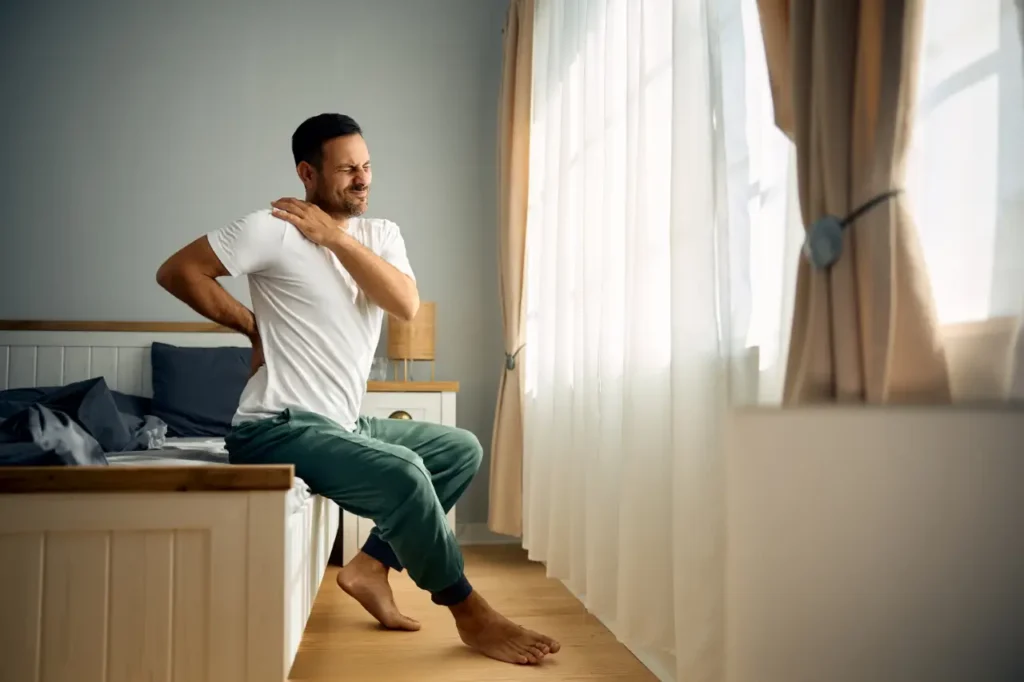 Adult experiencing inflammatory back pain and morning stiffness.