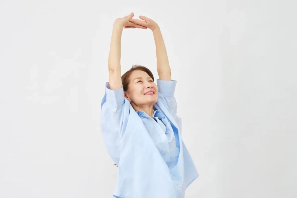 Elderly lady smiling and stretching
